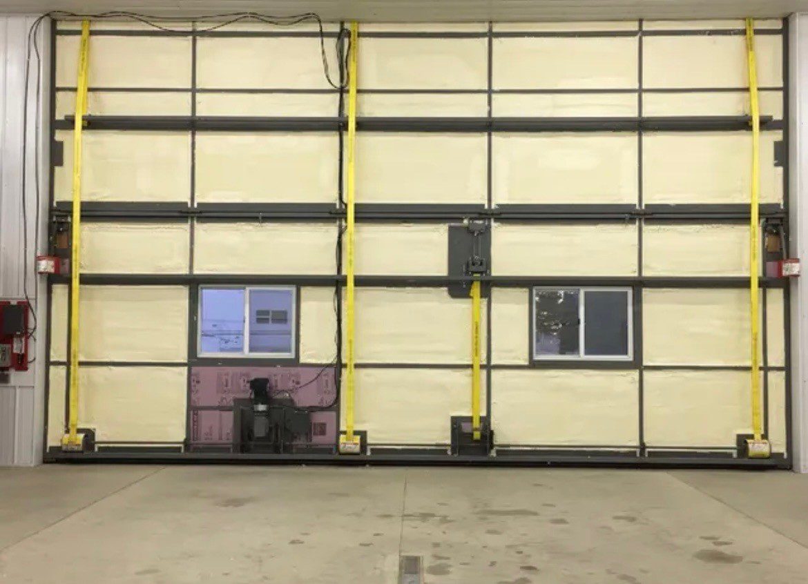 Midwest Foam & Insulation Commercial overhead exterior door spray foamed pic insulation installed on a commercial overhead door